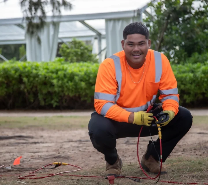 Field technician performing a seismic refraction survey for bedrock depth mapping, placing geophones and connecting cables to collect acoustic velocity data for non-invasive depth-to-bedrock analysis.