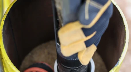 Technician lowers probe into borehole during Downhole geophysical imaging, collecting in-situ measurements to identify fractures, lithology, groundwater conditions, and structural features for geotechnical and environmental characterization.