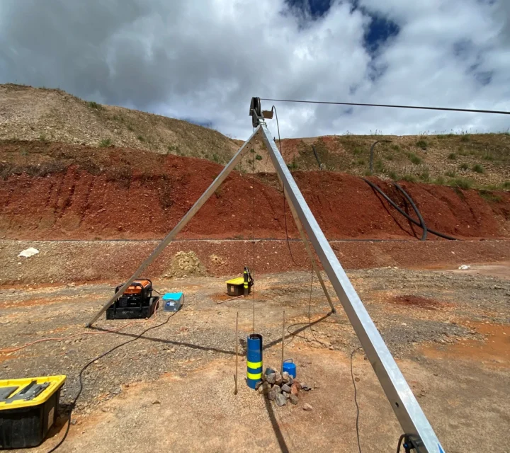 Downhole geophysical imaging equipment deployed over borehole with tripod and cable system, supporting borehole logging, formation characterization, and collection of subsurface measurements for geotechnical and environmental projects.