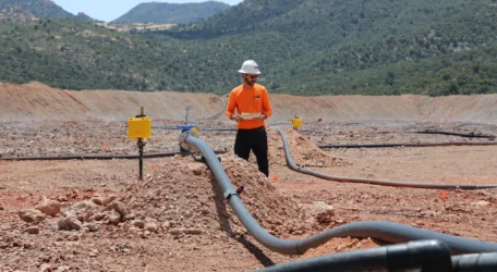 Technician inspects injection and monitoring lines during Enhanced metal recovery, collecting subsurface data on fluid distribution, pressure response, and under-leached zones to support optimization and improved resource extraction.