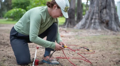 Technician installing electrodes for fracture mapping survey to identify subsurface faults and infiltration pathways affecting groundwater flow and stability.