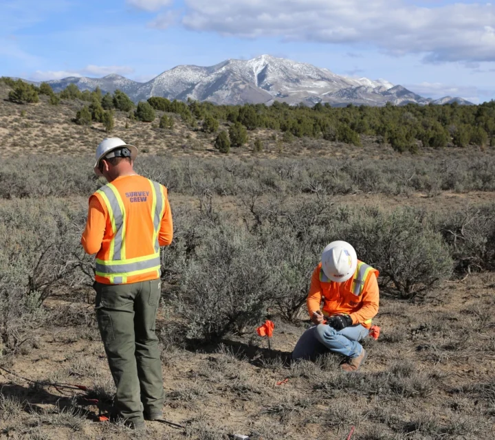Geophysical survey crew conducting fracture mapping in arid terrain, marking survey points and collecting subsurface data to identify infiltration zones, groundwater pathways, and structural controls influencing subsurface flow.