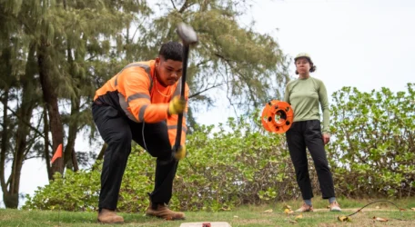 Field crew installing geophysical electrodes in shallow soil to investigate subsurface geohazards and identify potential risks to infrastructure and ground stability.