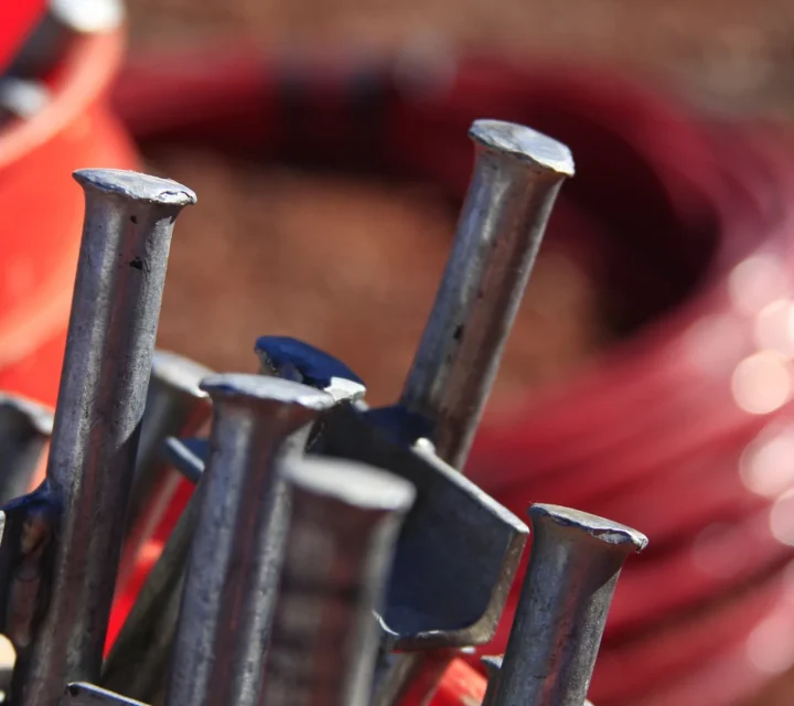 Close-up of field equipment used in geophysical methods, including survey spikes and cable for non-invasive subsurface characterization and data collection supporting geophysical investigations and mapping.