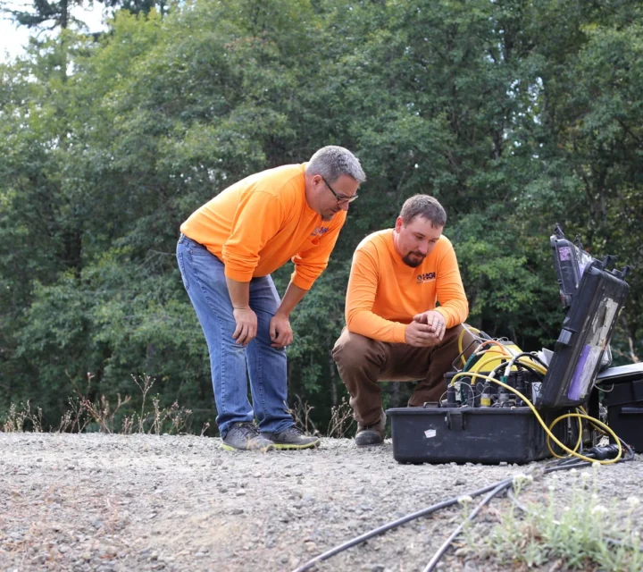 Technicians operating residual potential mapping equipment connected to electrode array to measure surface potentials and support electrical resistivity investigations of subsurface ionic anomalies, fluid pathways, and conductive targets.