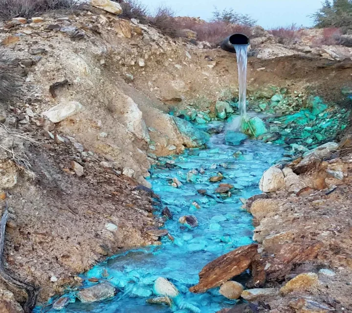 Acidic seep pond in mine area documented during Seepage and ARD mapping to identify impacted water pathways, internal erosion zones, and conditions contributing to acid rock drainage and environmental risk.